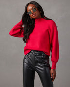 Red mock neck sweater with long sleeves and ribbed cuffs and hem