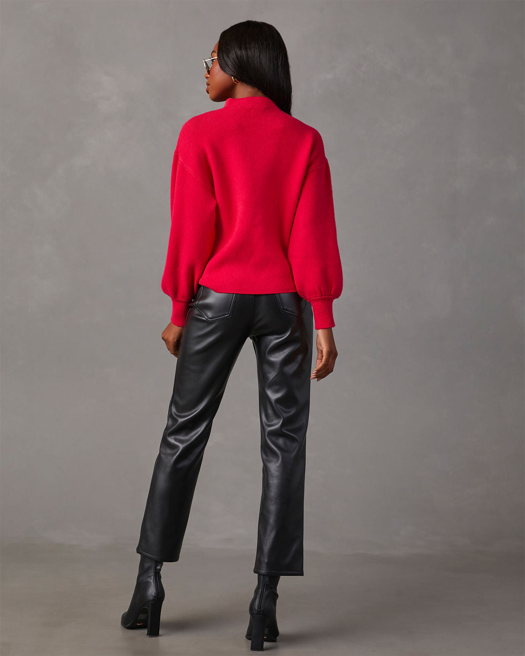Back view of red mock neck sweater with balloon sleeves