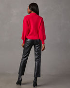 Back view of red mock neck sweater with balloon sleeves