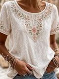 White floral embroidered eyelet blouse with rhinestone accents, round neck, short sleeves