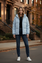 Light blue quilted hooded puffer jacket with front zipper and elastic cuffs