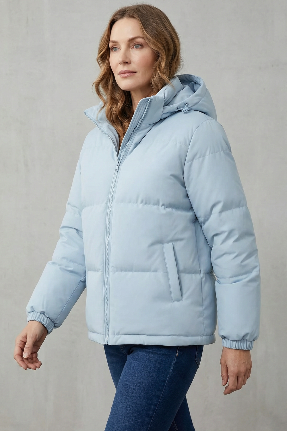 Light blue hooded puffer jacket with stand collar, zip front, and side pockets
