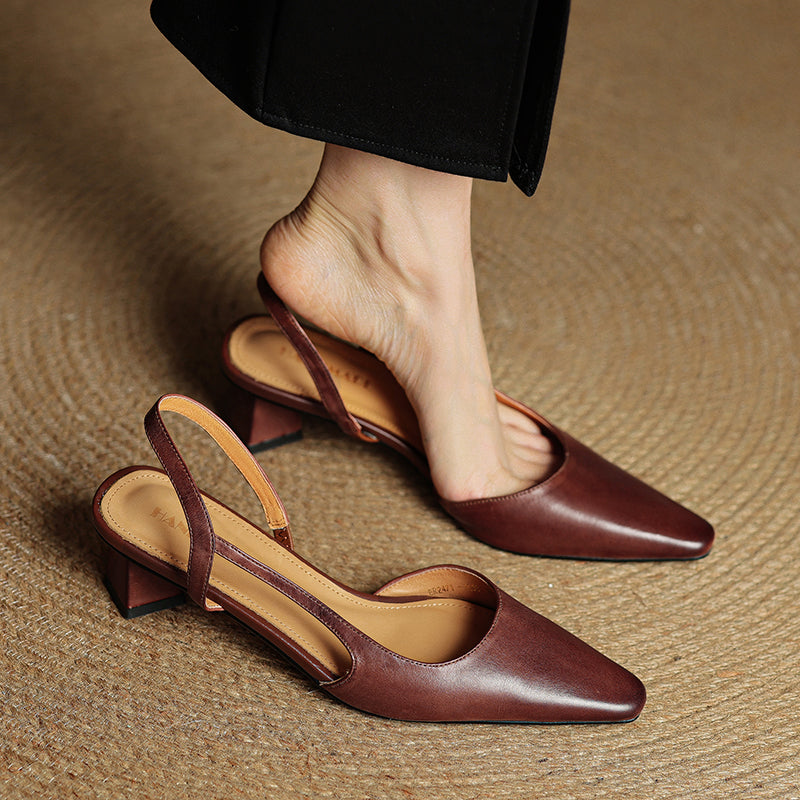 Pair of brown leather slingback heels with pointed toes and block heels.