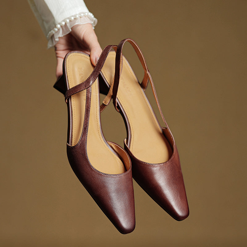 Brown leather slingback heels with pointed toes and beige interior lining.