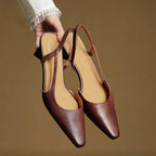 Brown leather slingback heels with pointed toes and beige interior lining.