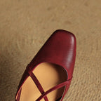 Red leather pointed-toe sandal with slingback strap and cross-strap upper