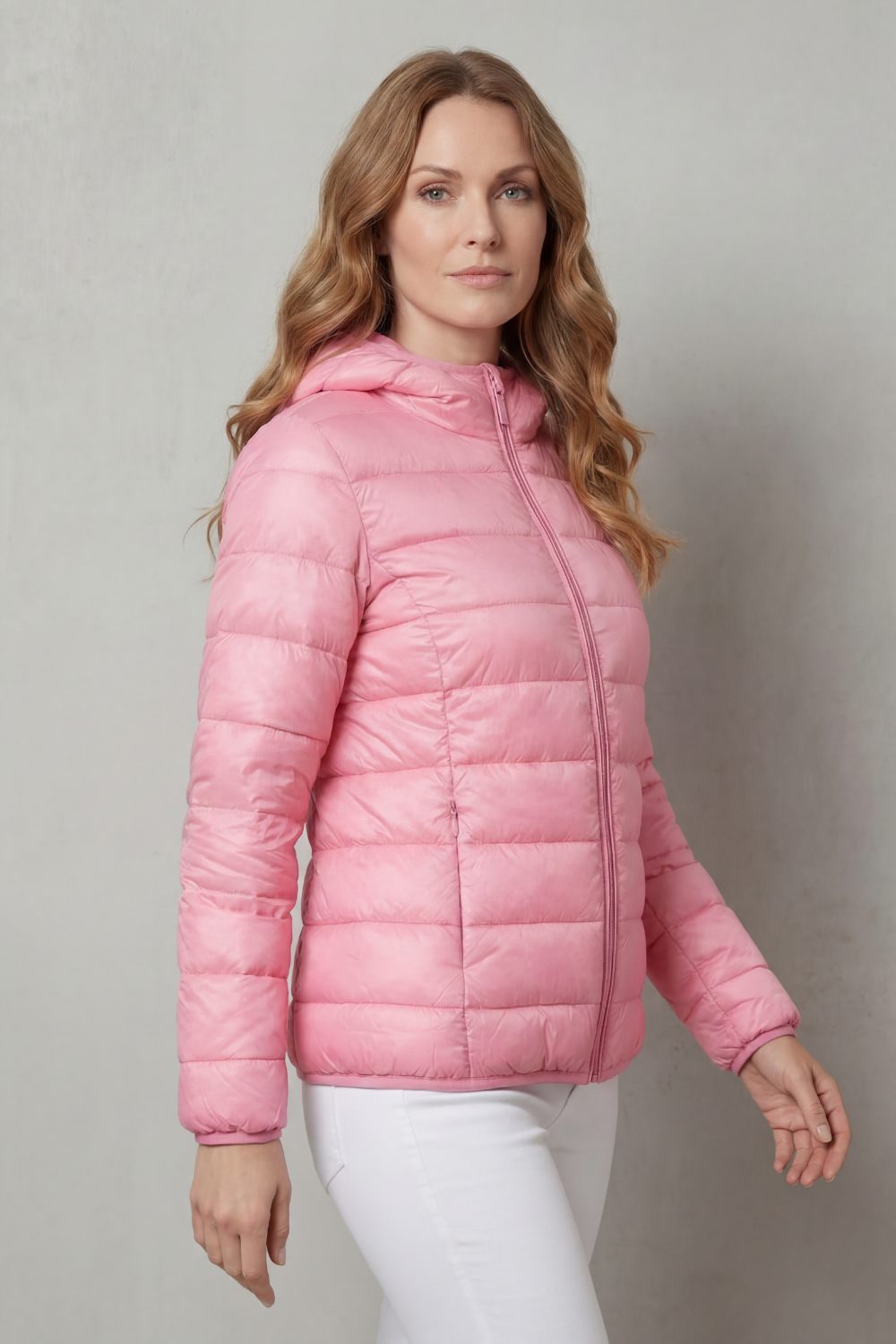 Pink hooded puffer jacket with quilted pattern and zip front, side view