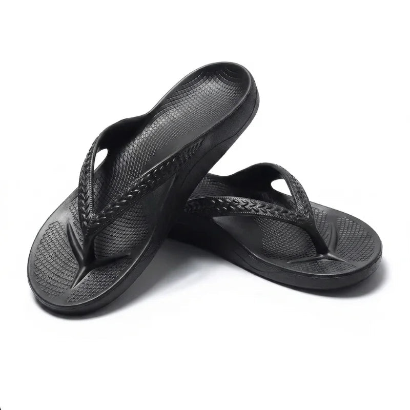 Black thong flip flops with textured footbed and braided strap stitching