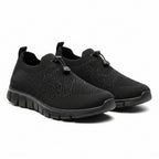 Black knit slip-on shoes with wide toe box and white cushioned sole