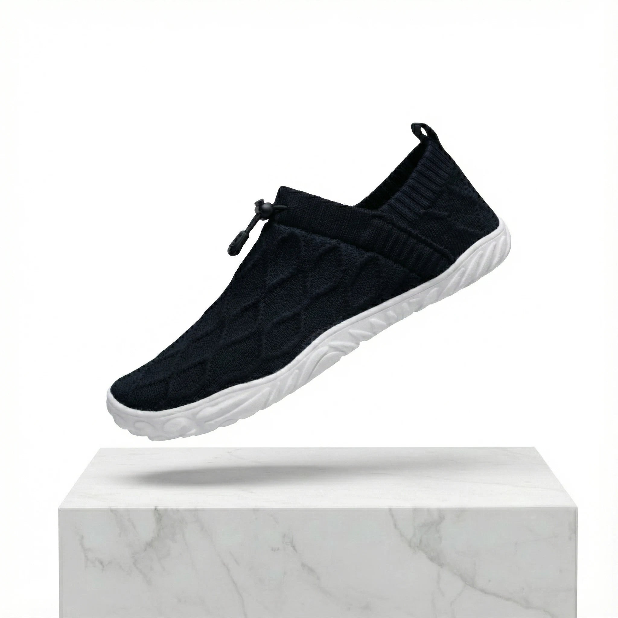 Black knit slip-on shoes with elastic collar and white cushioned sole