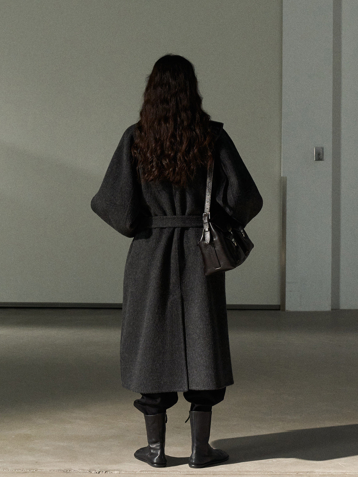 Dark gray long wool belted coat with stand collar, back view
