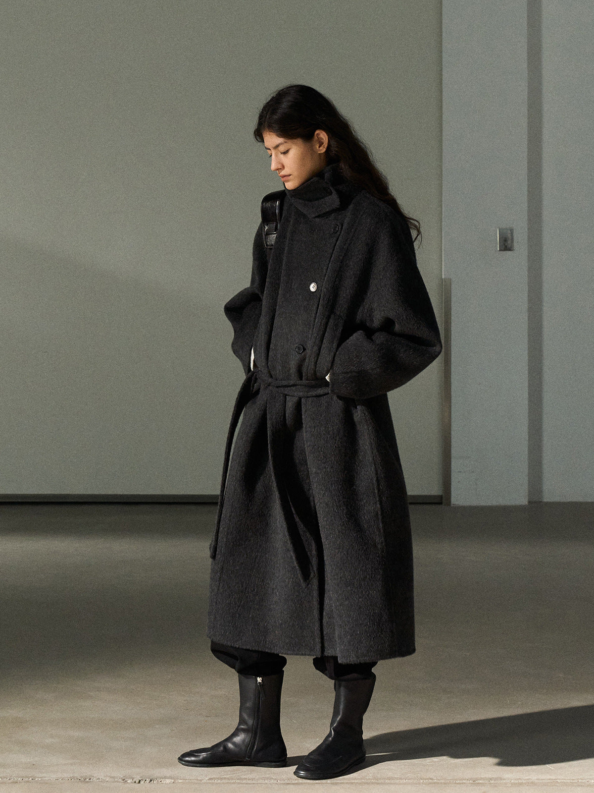 Dark gray wool long coat with stand collar and tie belt, front view