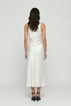White satin midi dress with draped back neckline and ruched waist, sleeveless