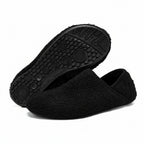 Black cozy slip-on barefoot slippers with textured rubber outsole view
