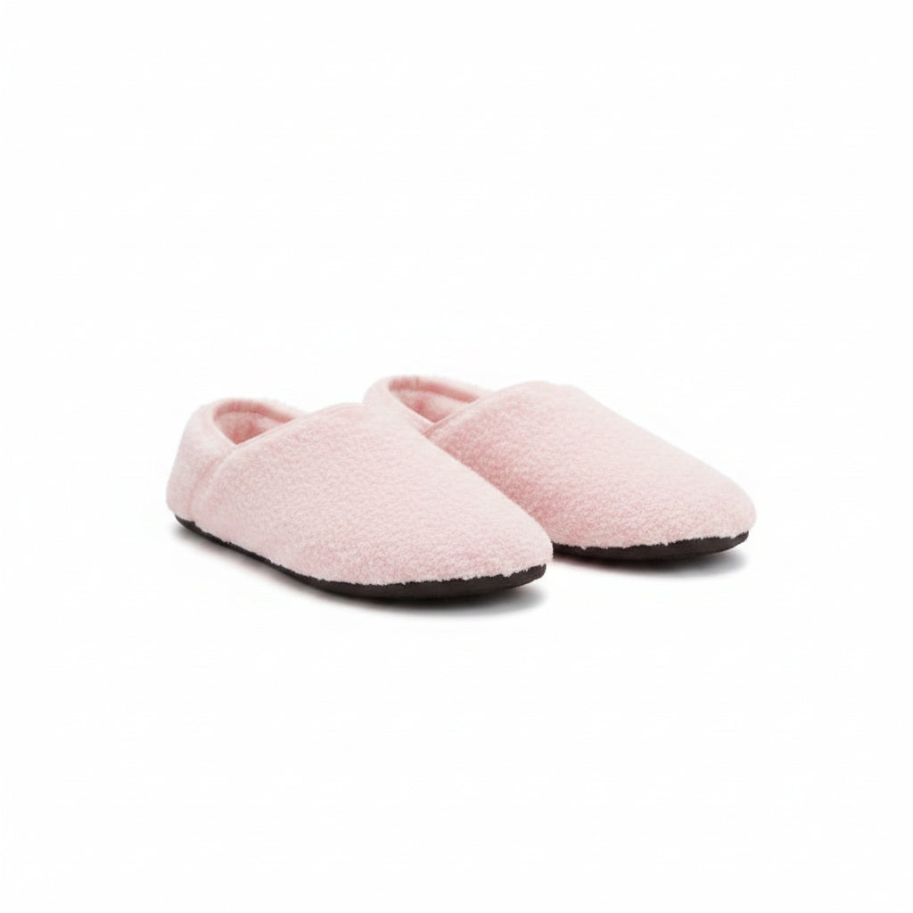 Pink fuzzy slip-on barefoot slippers on feet, low profile and soft lining