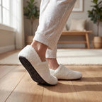 White cushioned slip-on barefoot slippers worn with dark rubber outsole showing