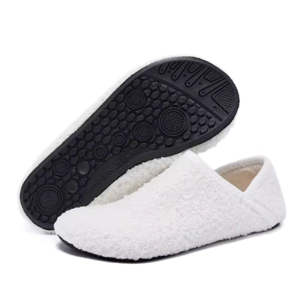 White cozy slip-on barefoot slippers with black textured outsole view