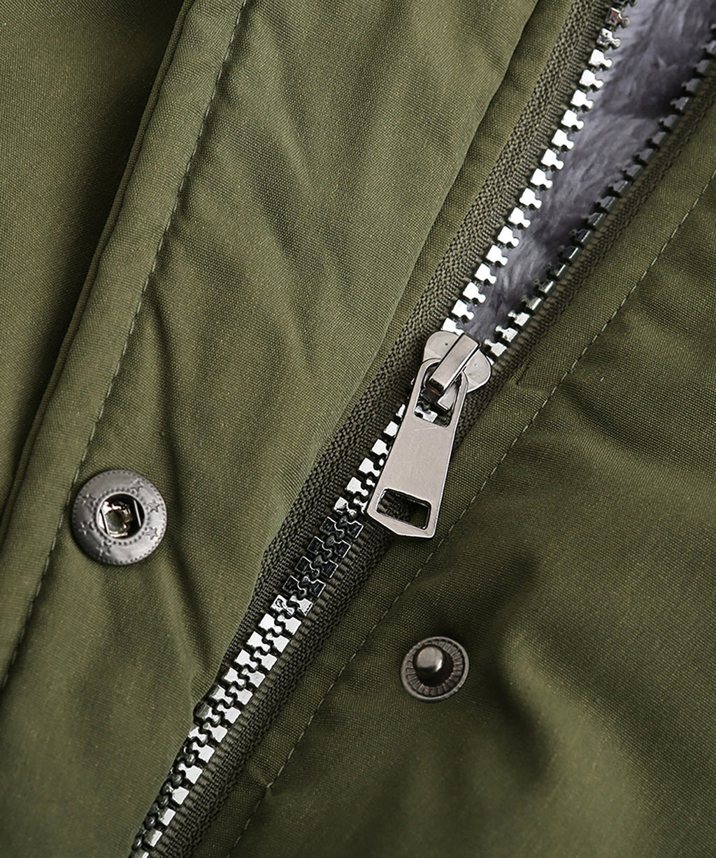 Close-up of olive green parka zipper and snap buttons with metal hardware