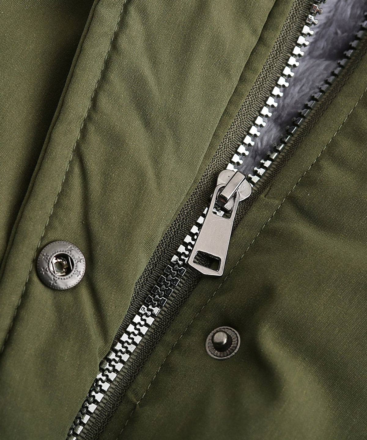 Close-up of olive green parka zipper and snap buttons with metal hardware