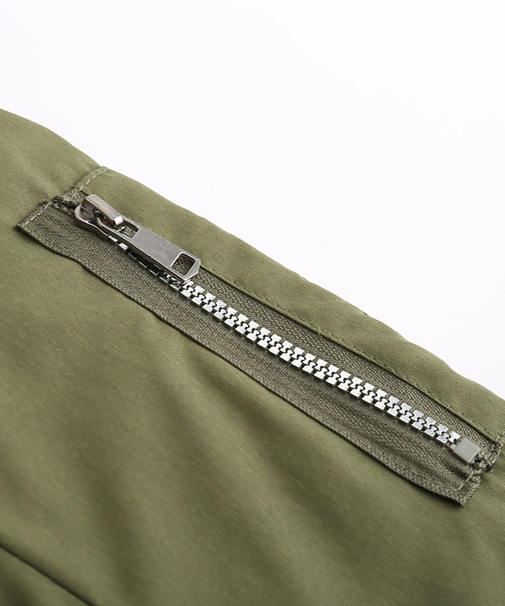 Close-up of olive green parka zipper with silver-toned pull and teeth