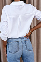 White oversized button-up long sleeve shirt, back view with center pleat