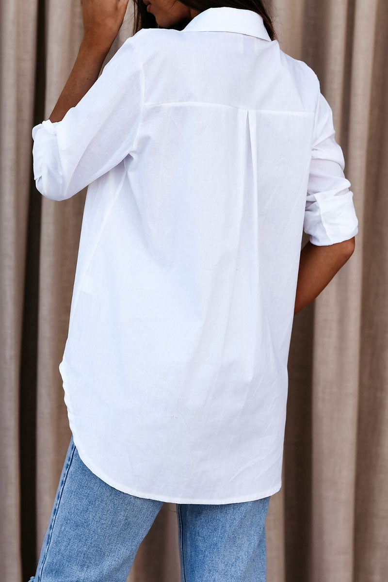 White oversized button-up long sleeve shirt, rear view with high collar