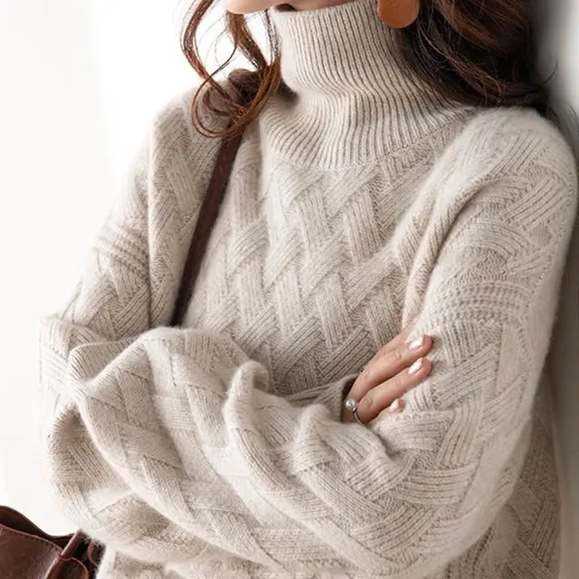 Light beige cable-knit turtleneck sweater with raised diamond stitch pattern