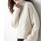 Cream cable-knit turtleneck sweater with long sleeves and diamond pattern
