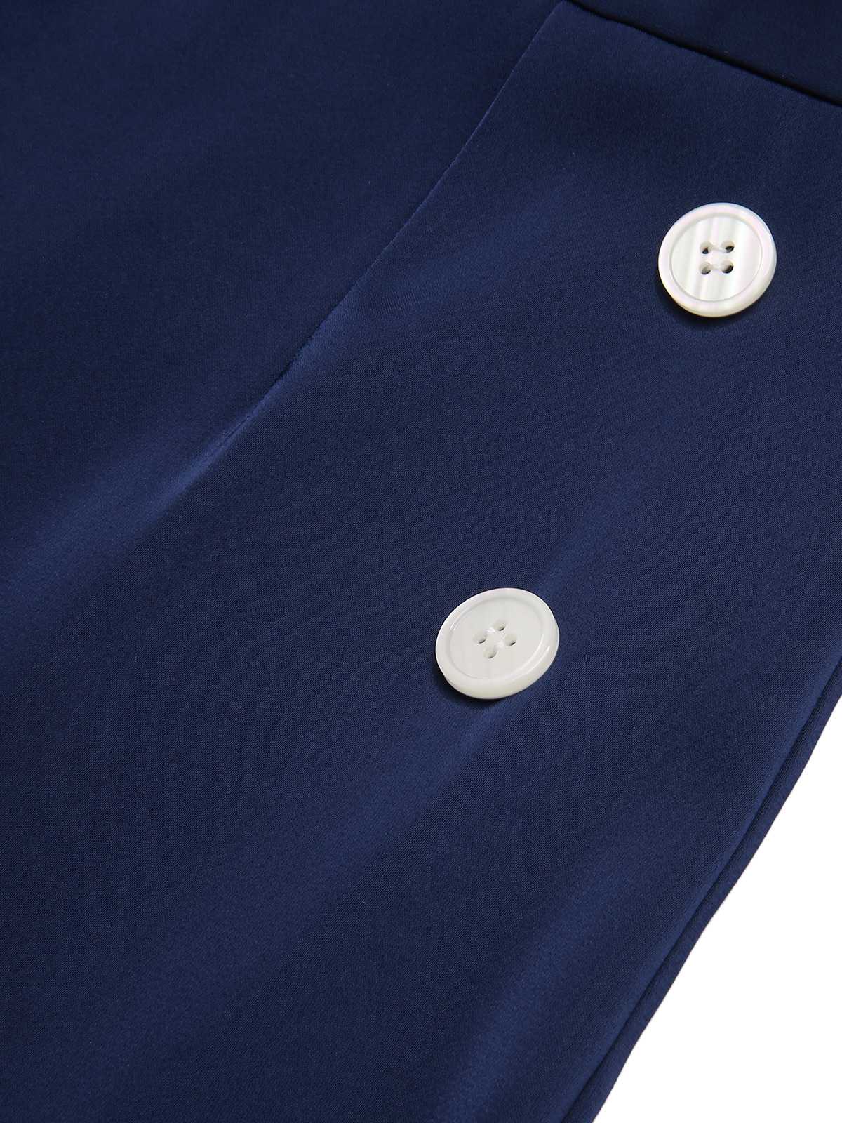 Close-up of dark blue jumpsuit fabric with white button and seam