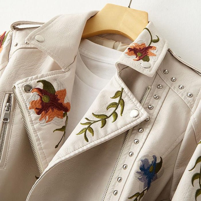 Pearl white leather jacket detail with embroidered florals, snap collar, zip front