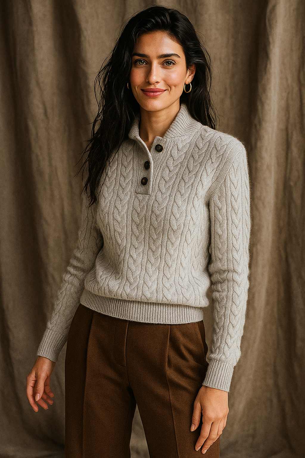 Light gray-white cable-knit sweater with dark buttons and ribbed cuffs