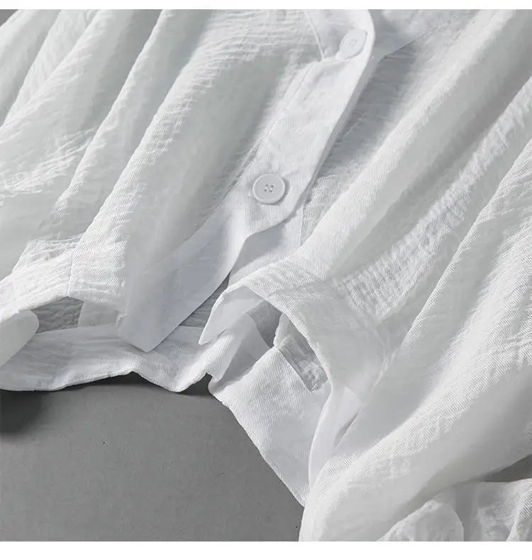 White linen blouse with relaxed fit and buttoned neckline detail