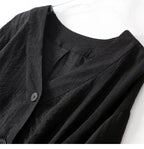 Black linen blouse close-up: V-neck facing and front button placket