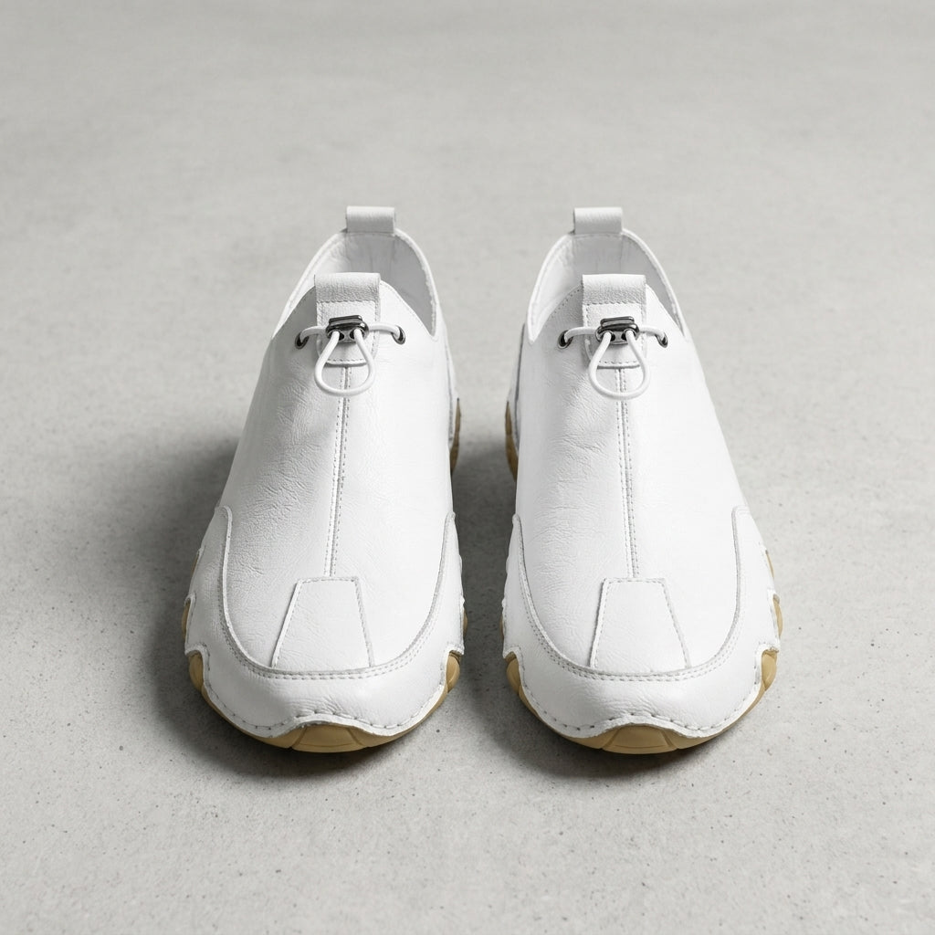 White leather casual sneaker with lace-up, padded collar, and rubber sole.