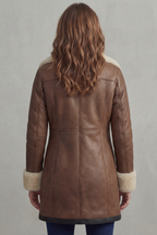 Brown leather winter coat back view with seam lines and shearling cuff trim