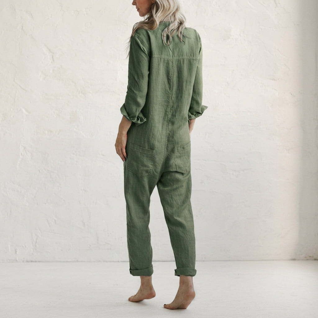 Green linen jumpsuit with button front, V-neck collar, long sleeves, and front patch pockets