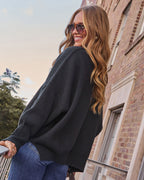 Black oversized knit pullover sweater, side view with roomy dropped shoulders