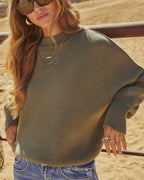 Olive green knit pullover sweater with ribbed crew neck and textured knit pattern