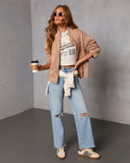 Quilted zip-front jacket in tan with stand collar and long sleeves, stitched panel design