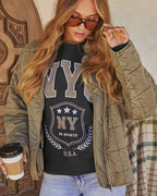 Olive quilted jacket with zip-front, elastic cuffs, and long sleeves; front close-up.
