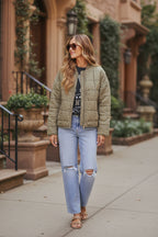 Olive quilted jacket with zip-front and long sleeves, standing collar; front view.