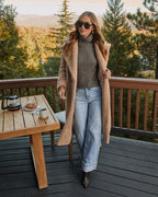 Cream teddy coat with side pockets and open front, long straight silhouette
