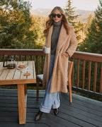 Cream teddy coat with side pockets, long sleeves, textured plush finish