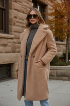 Cream teddy coat with open front and side pockets, fuzzy sherpa-like texture