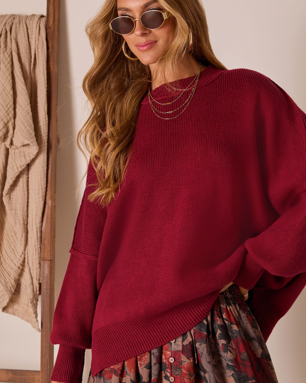 Burgundy oversized knit pullover sweater with ribbed crew neck and wide cuffs