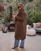 Brown teddy coat with side pockets, long sleeves, textured teddy fabric over knit