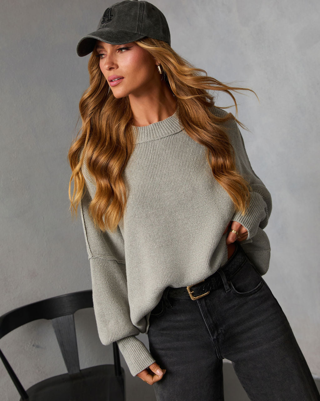 Heather gray oversized knit sweater with crew neck and ribbed cuffs, relaxed fit.