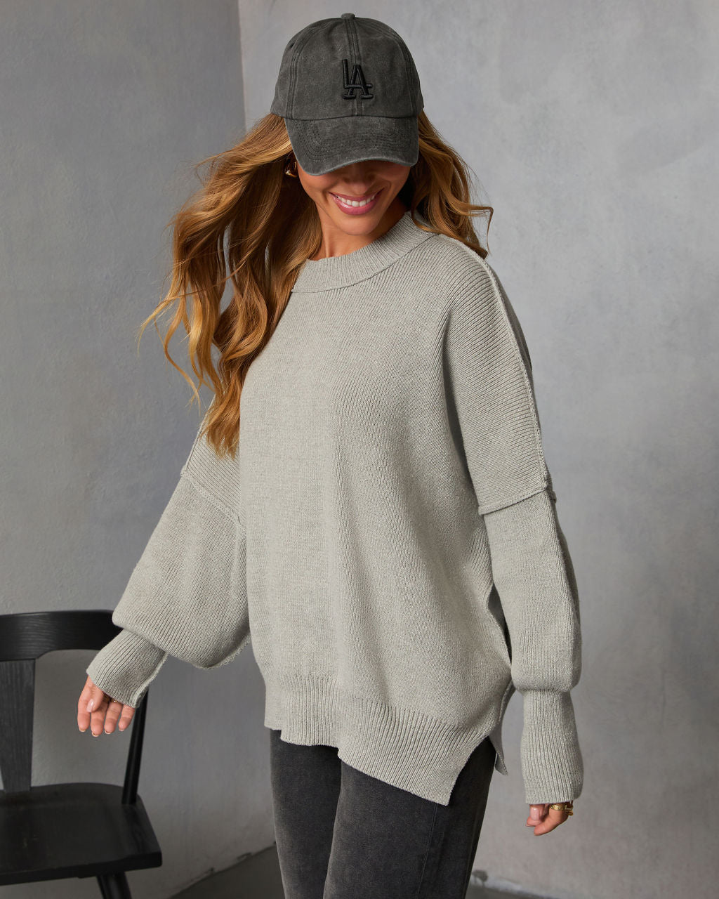 Heather gray oversized knit sweater with crew neck and ribbed cuffs, relaxed fit.