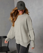 Heather gray oversized knit sweater with crew neck and ribbed cuffs, relaxed fit.
