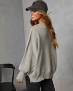 Heather gray oversized knit pullover with crew neck, ribbed cuffs, and hem (side view).